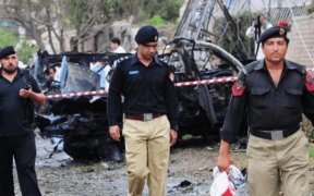 In Peshawar's Badaber neighbourhood, a police car narrowly avoids a bomb detonation.