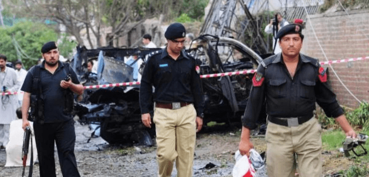 In Peshawar's Badaber neighbourhood, a police car narrowly avoids a bomb detonation.